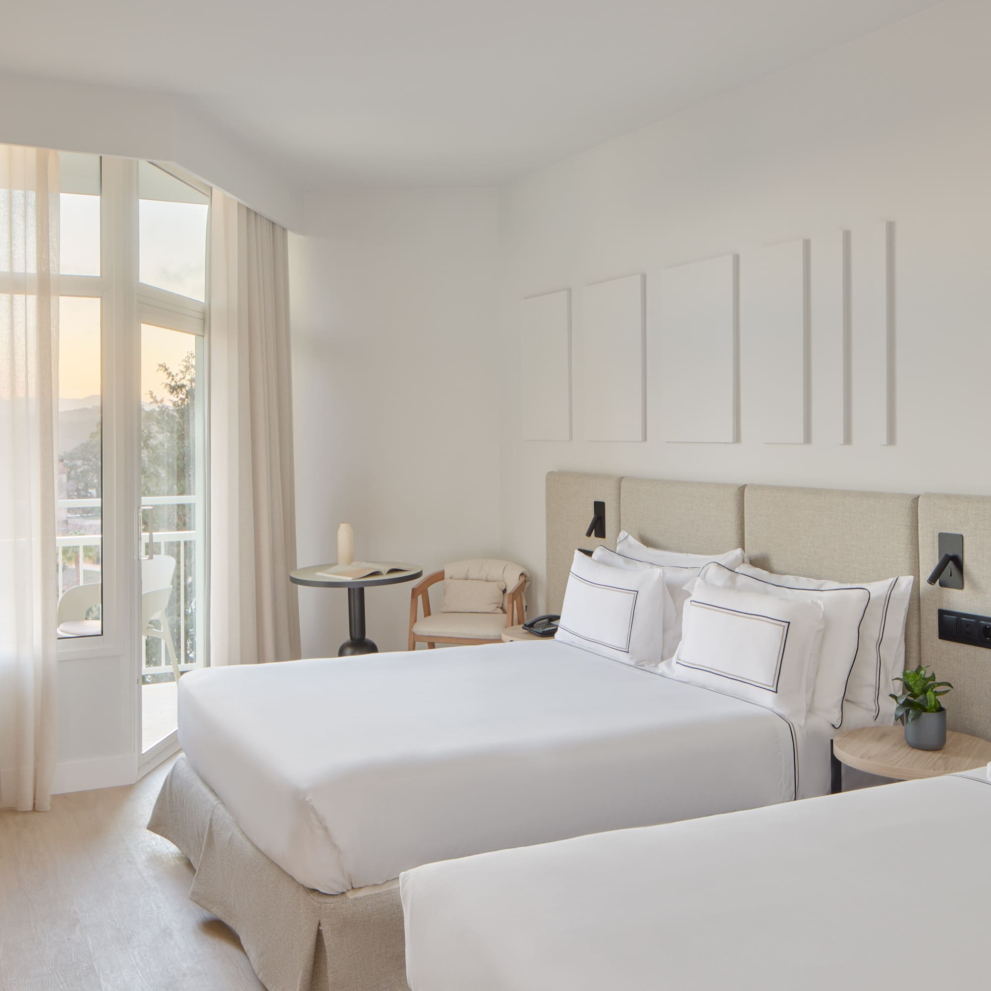 a room with two beds and a balcony