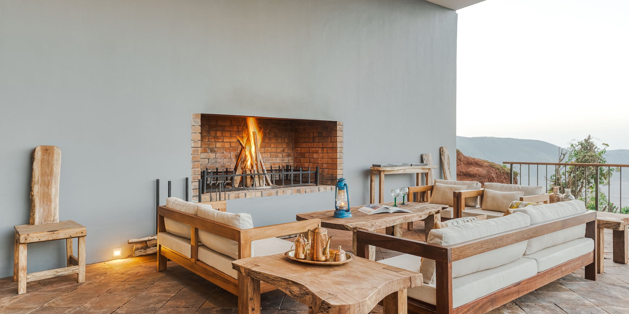 a patio with a fireplace and furniture