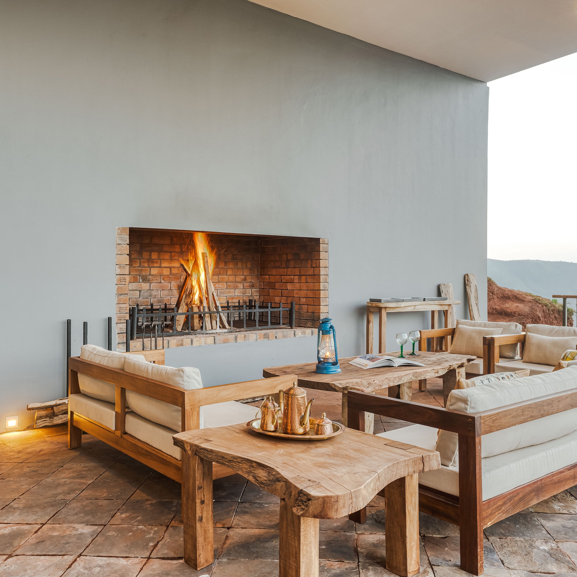 a patio with a fireplace and furniture