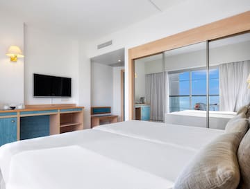 a room with a bed and a television