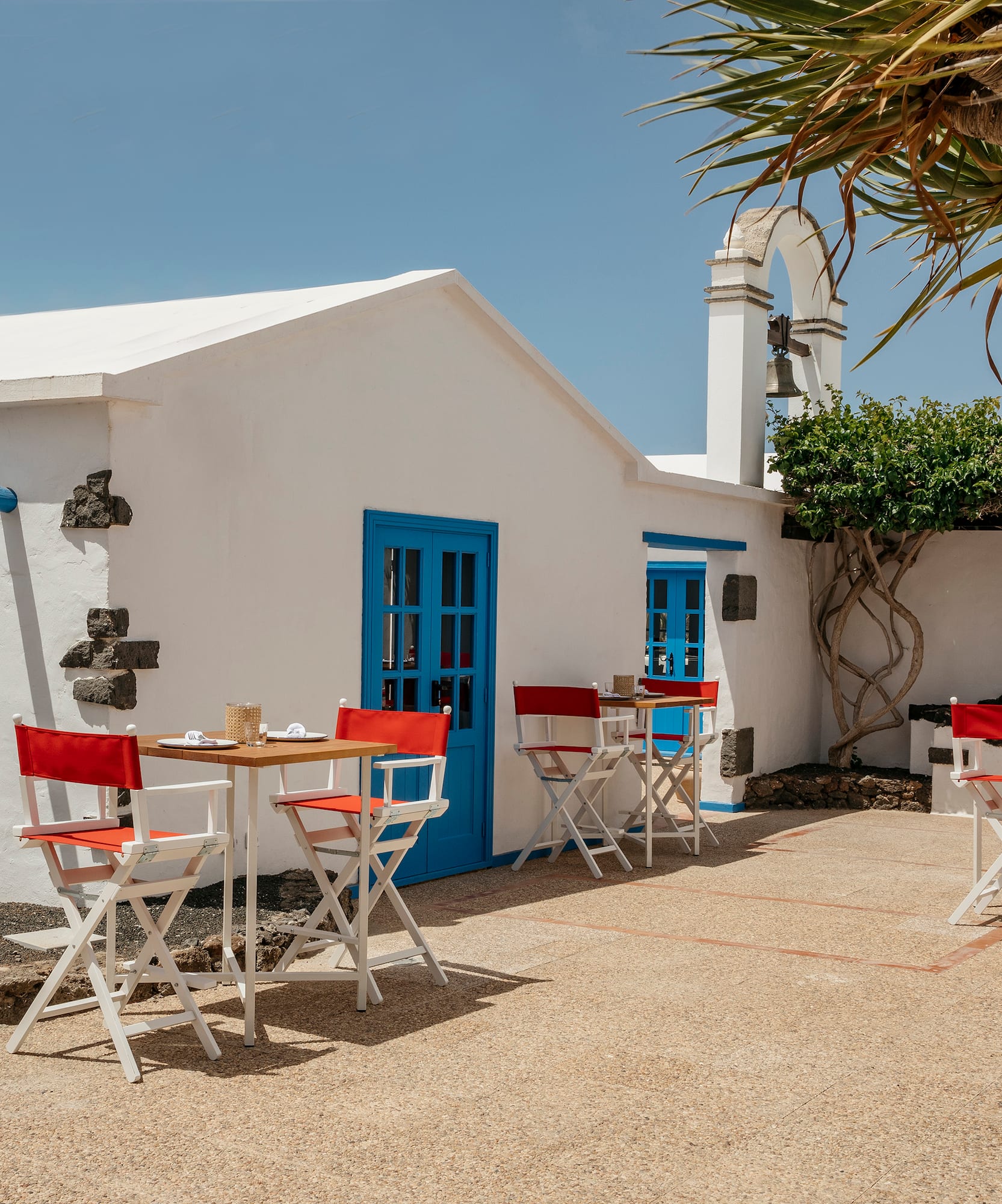 a white building with tables and chairs