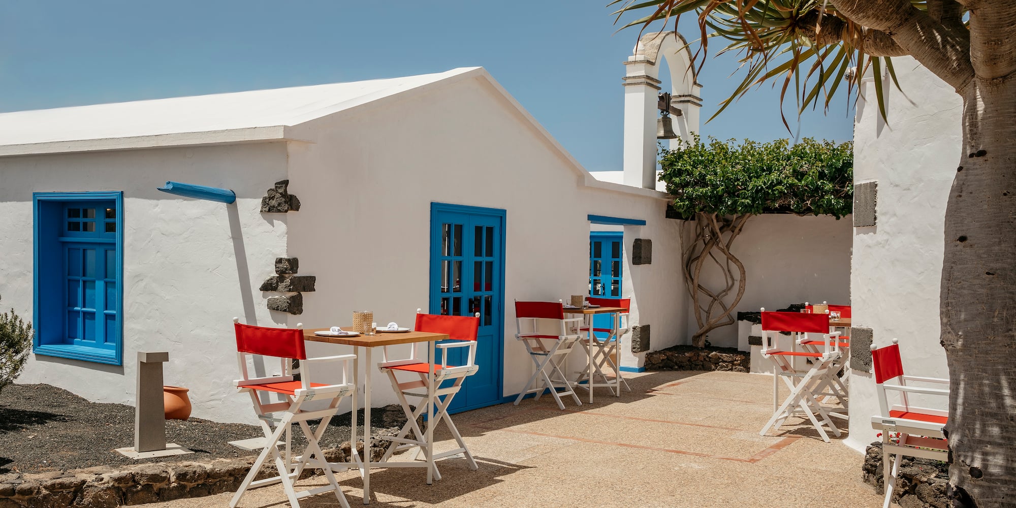 a white building with tables and chairs