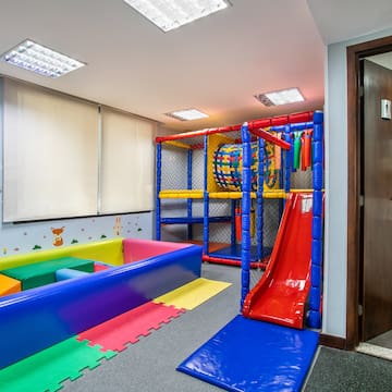 a playroom with a slide and a play structure
