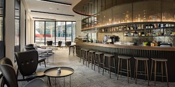 a bar with a counter and chairs
