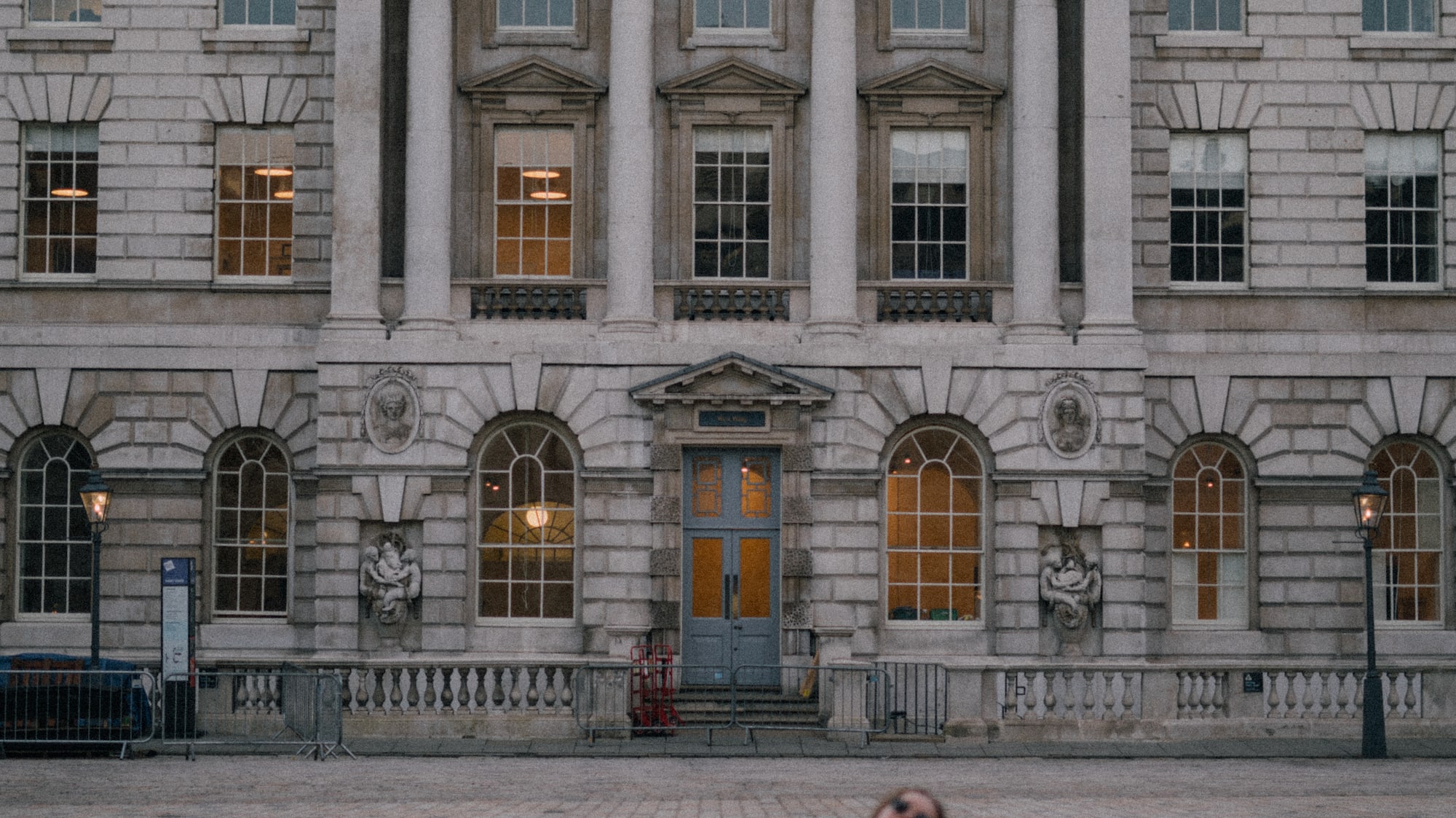 a person sitting on a chair in front of a building