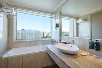 a bathroom with a large window and sink