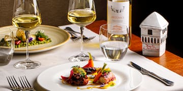 a plate of food and wine glasses on a table