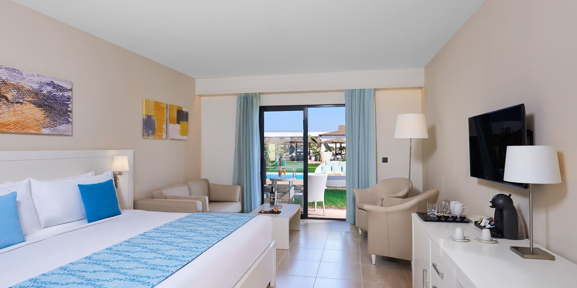 a room with a bed and a television