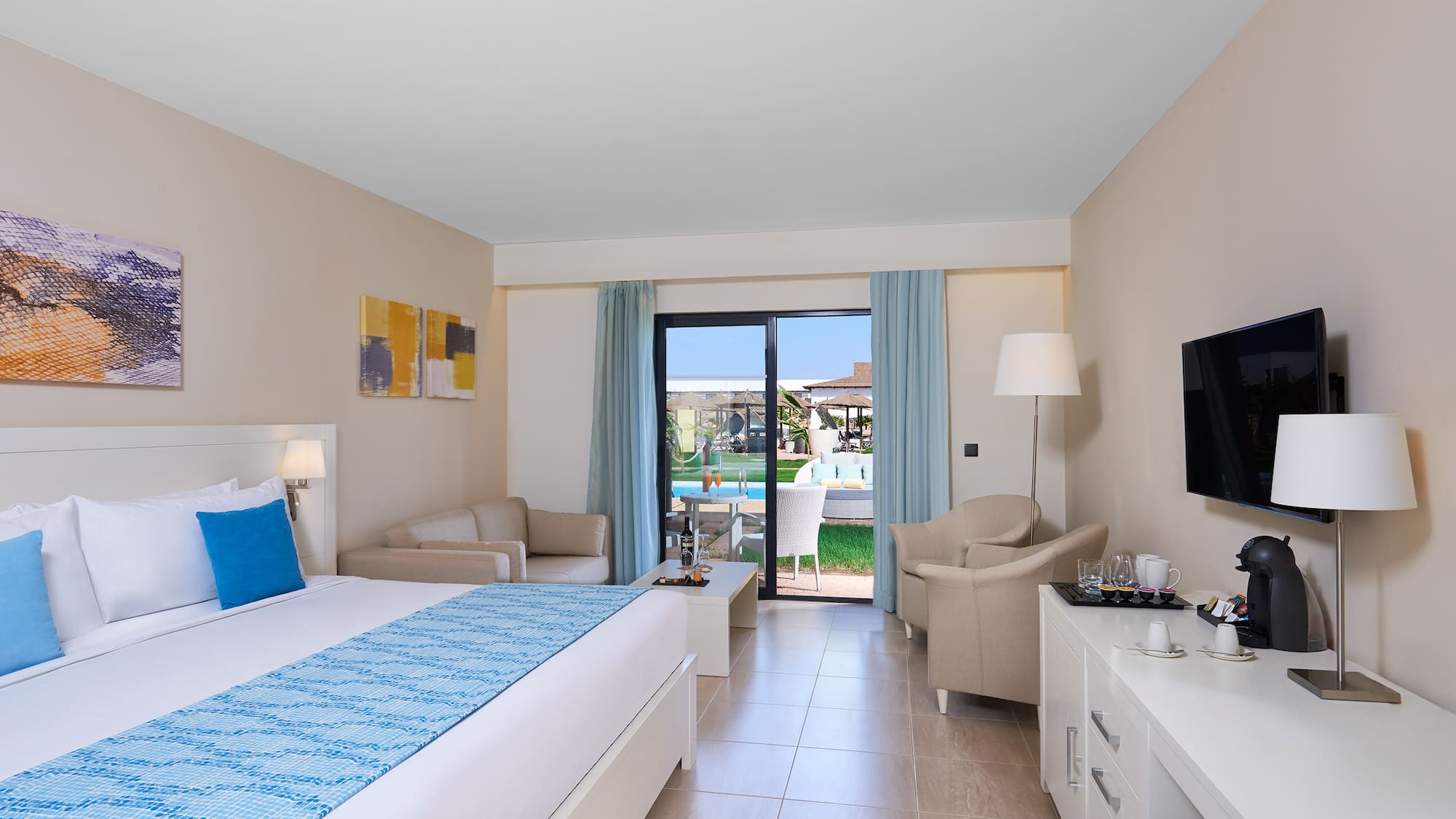 a room with a bed and a television