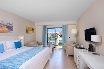 a room with a bed and a television