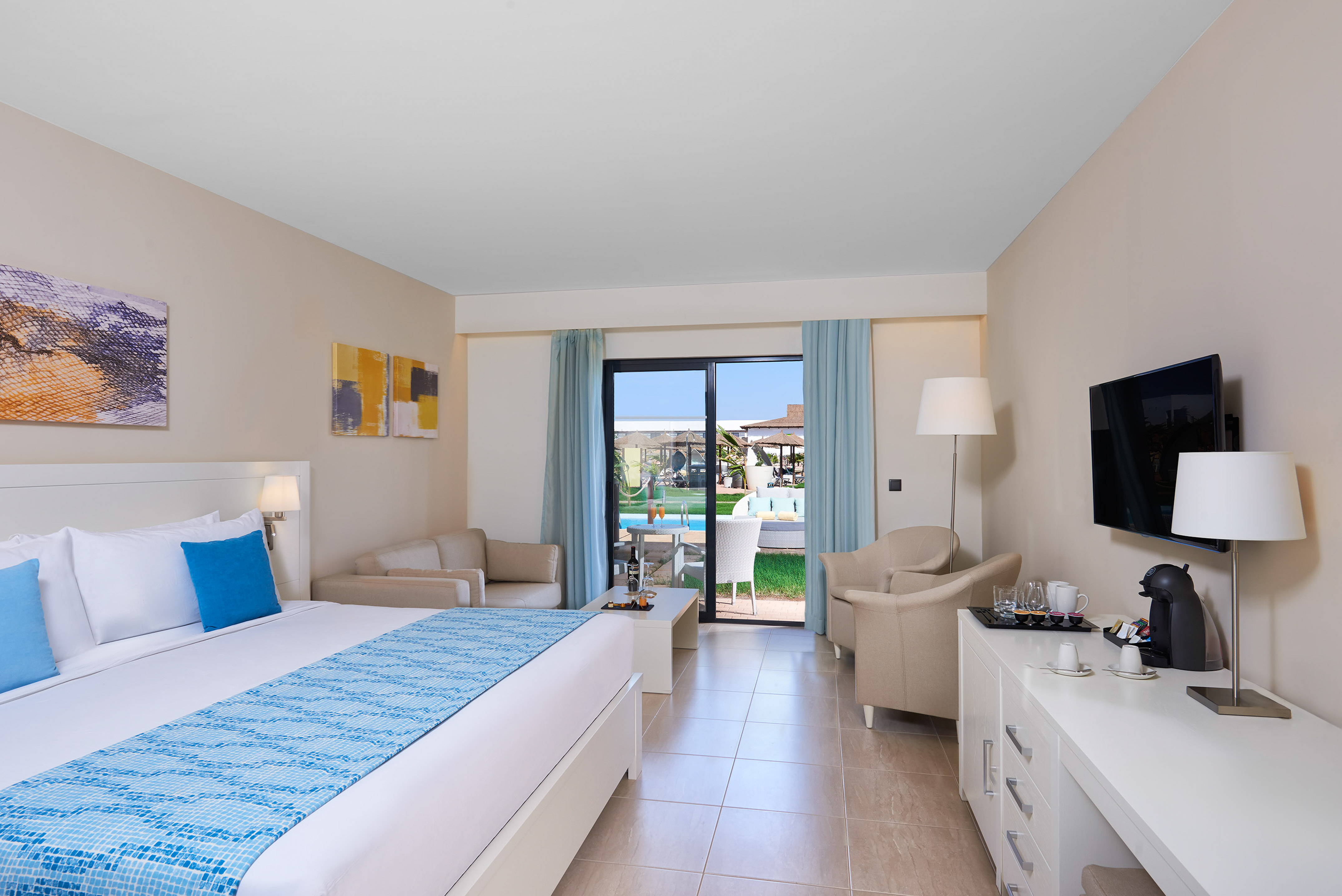 a room with a bed and a television