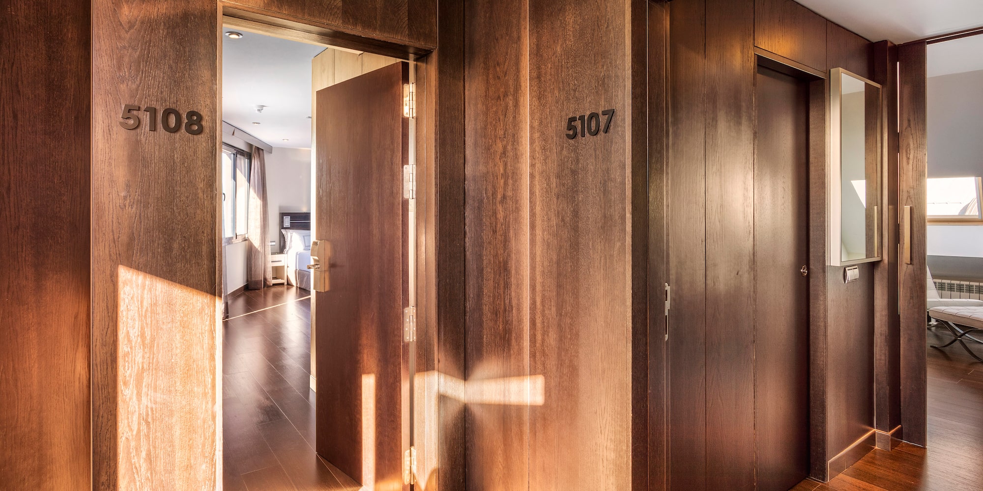 a hallway with doors and a wood floor