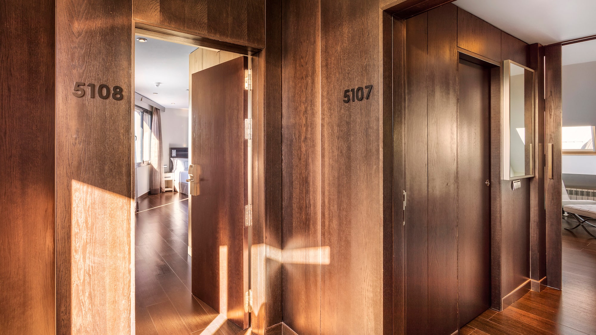 a hallway with doors and a wood floor