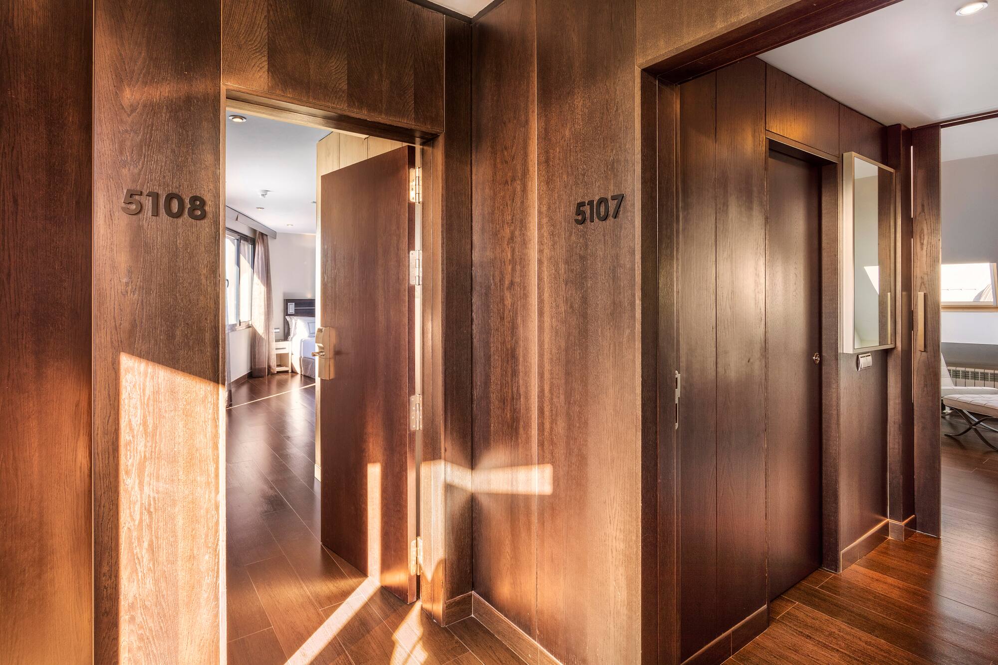 a hallway with doors and a wood floor