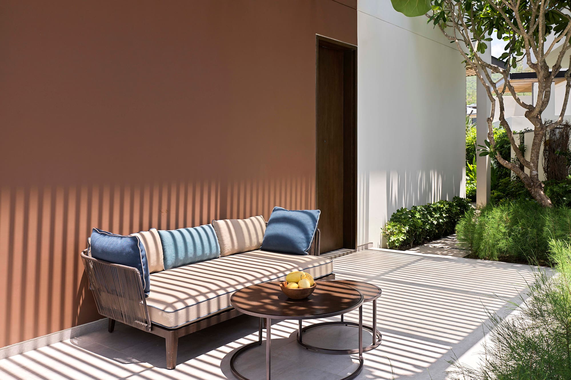 a couch and a table outside of a house