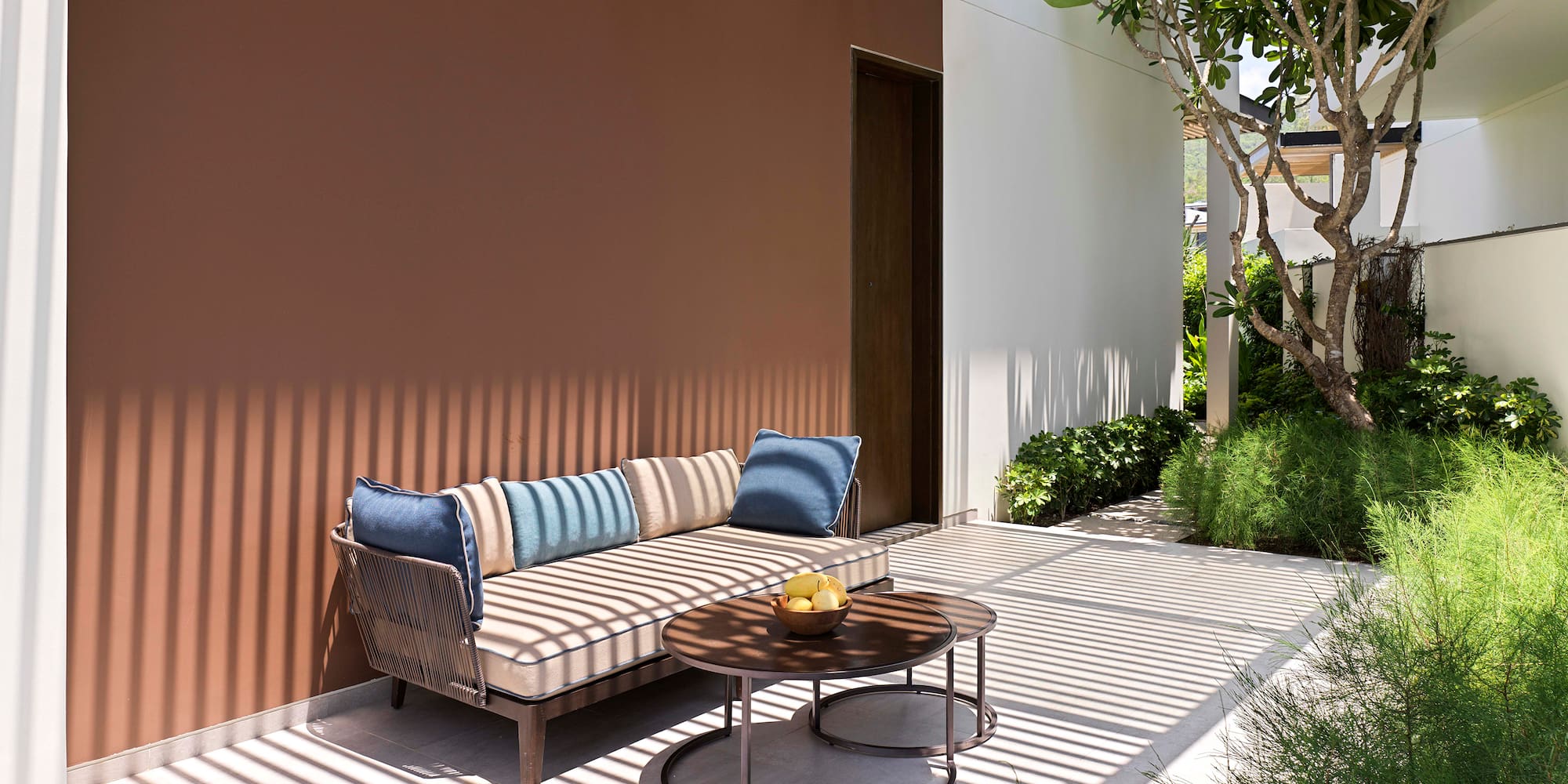 a couch and a table outside of a house