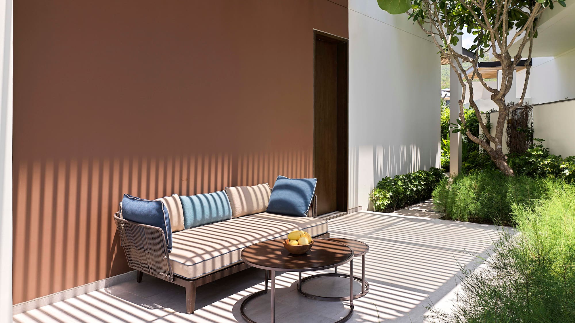 a couch and a table outside of a house