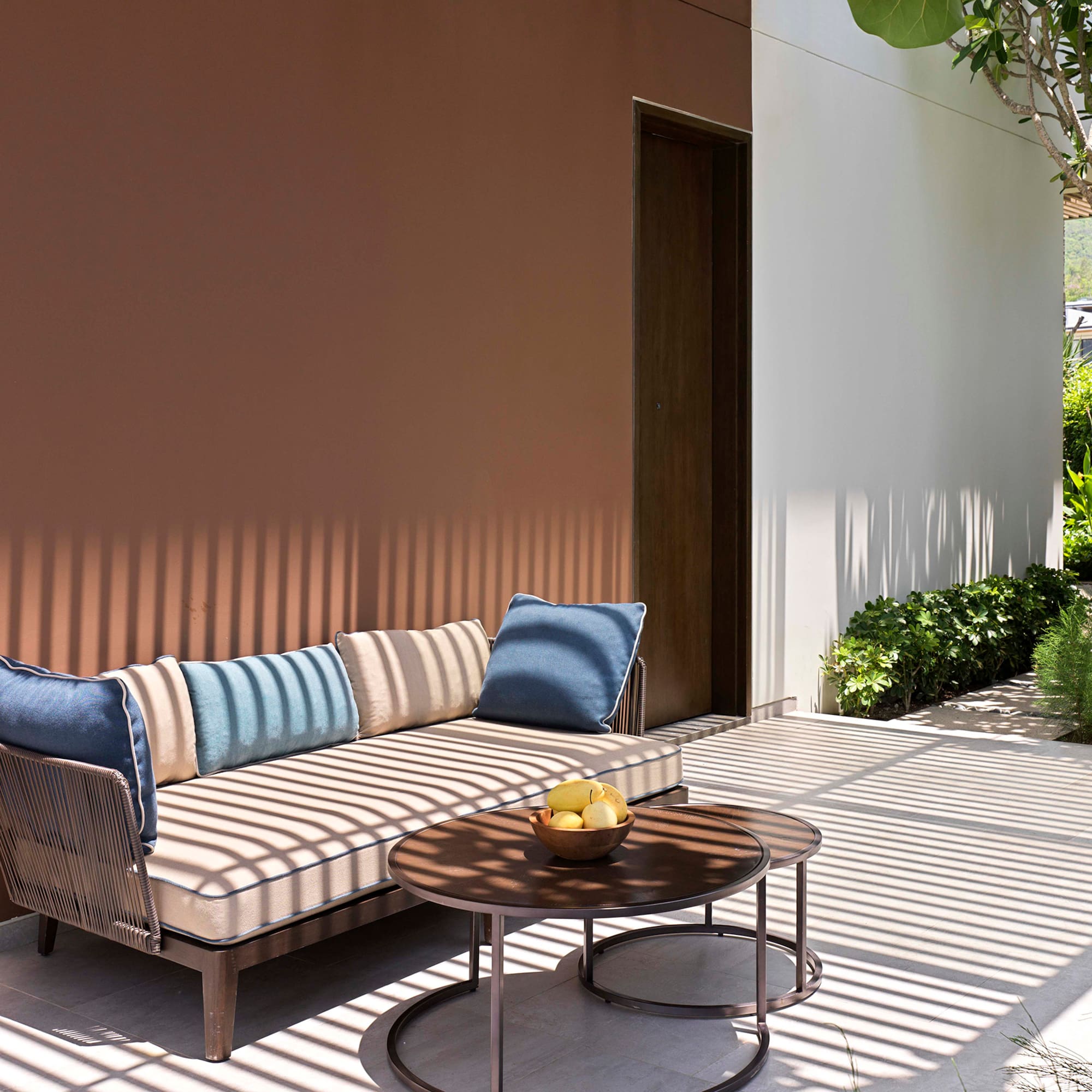 a couch and a table outside of a house