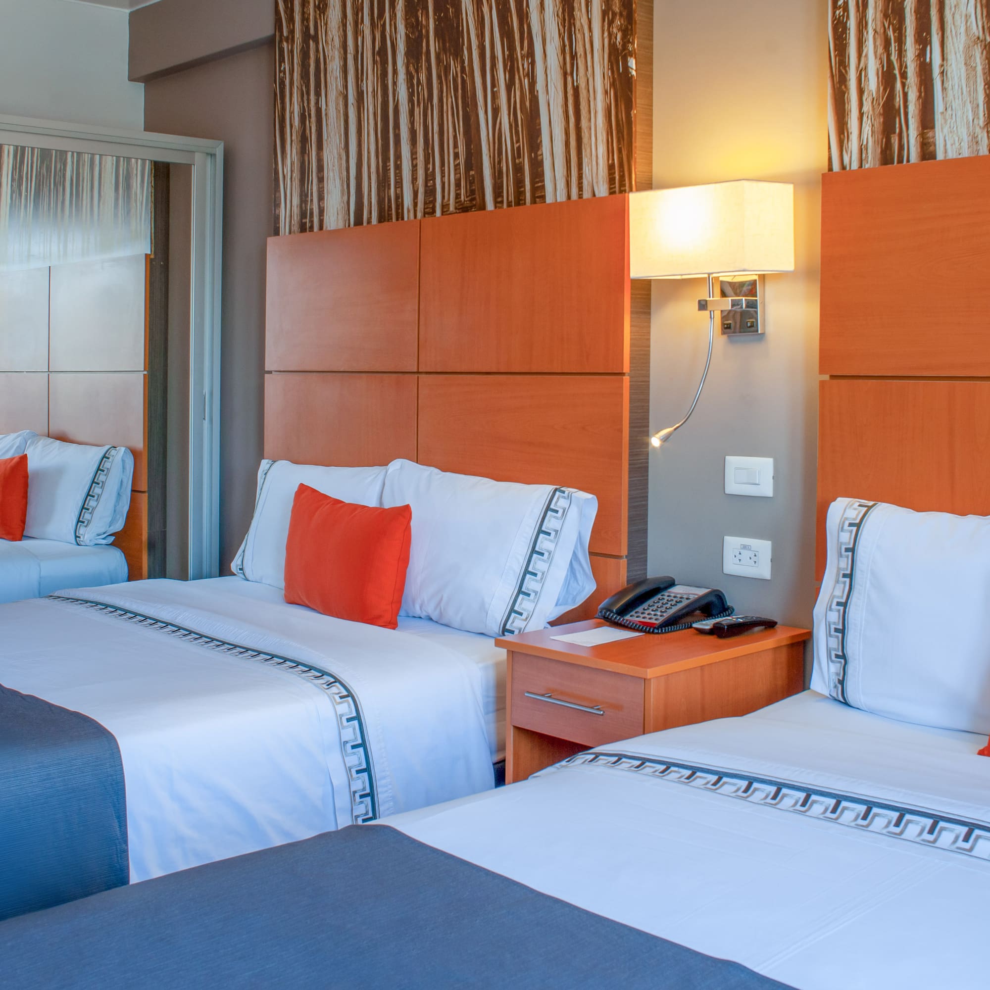a room with two beds and a telephone