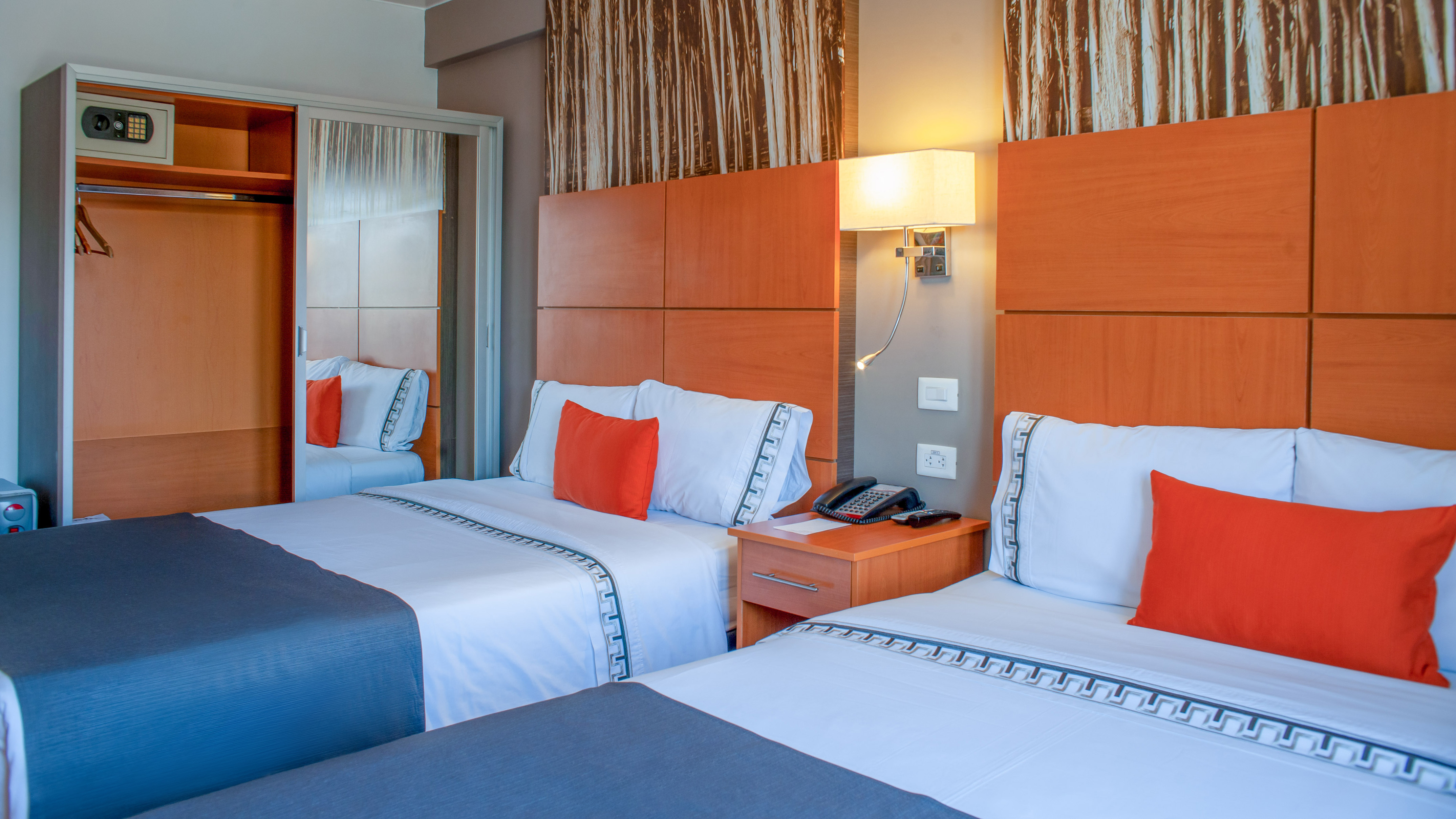 a room with two beds and a telephone