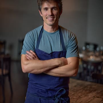 a man wearing a blue apron