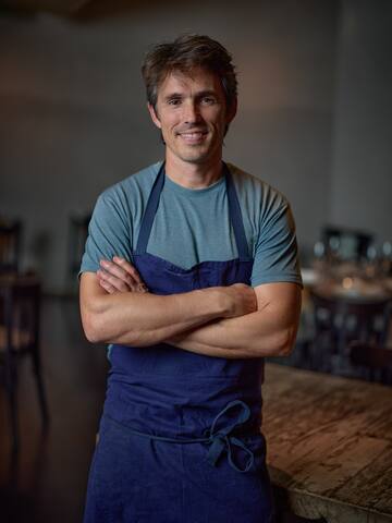 a man wearing a blue apron