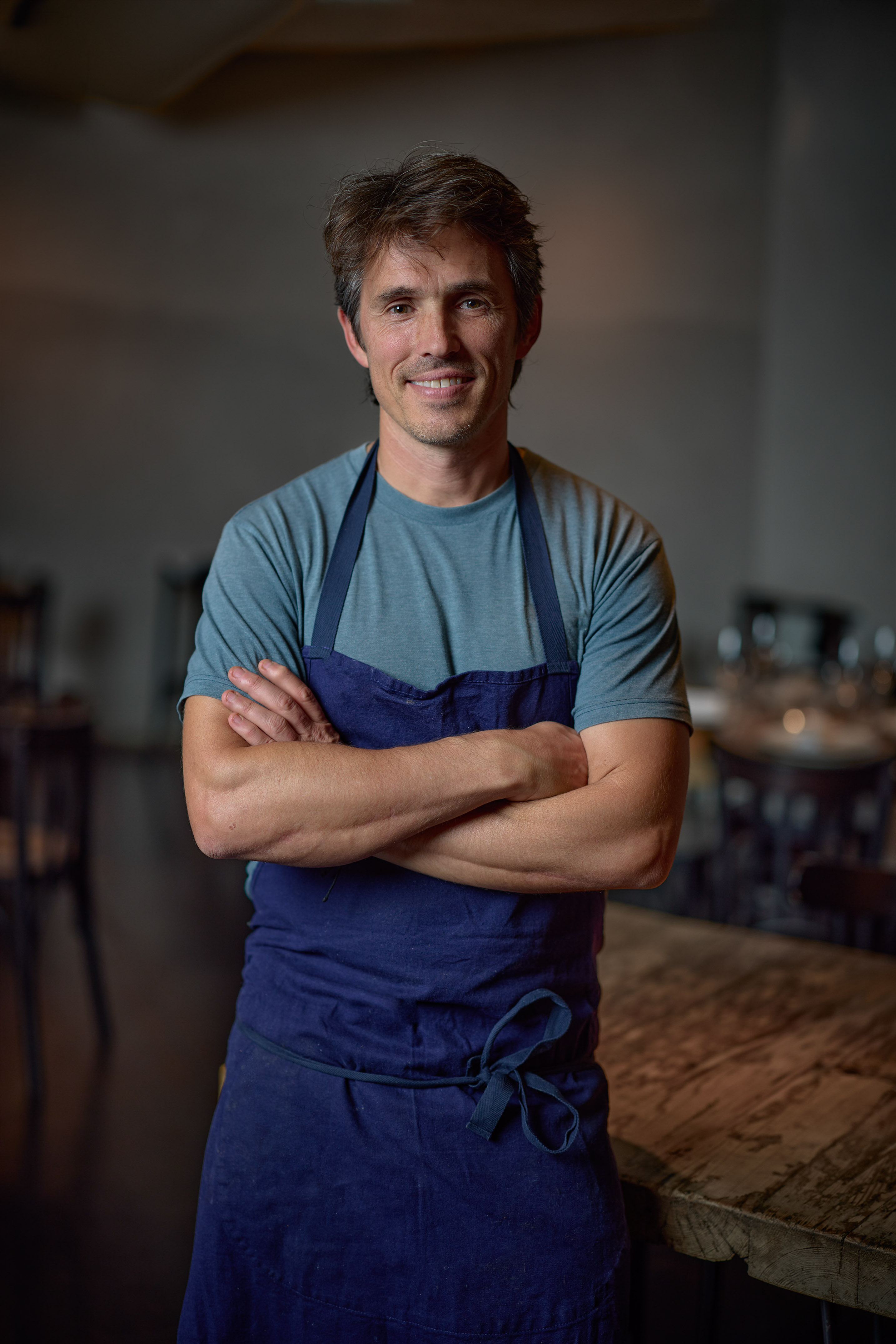 a man wearing a blue apron