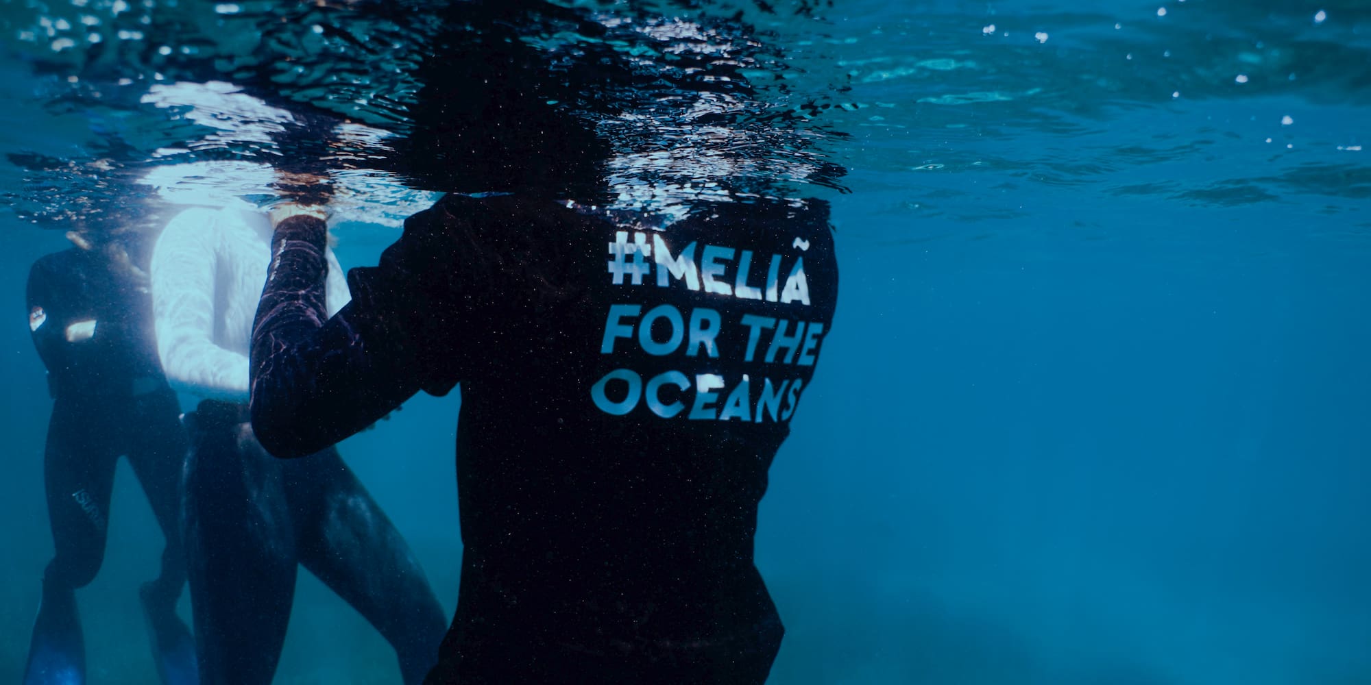 a person under water with a shirt on