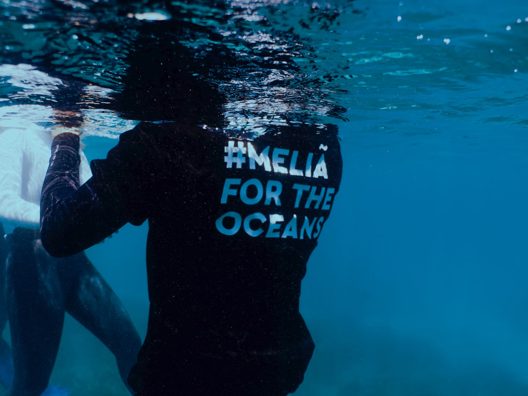 a person under water with a shirt on