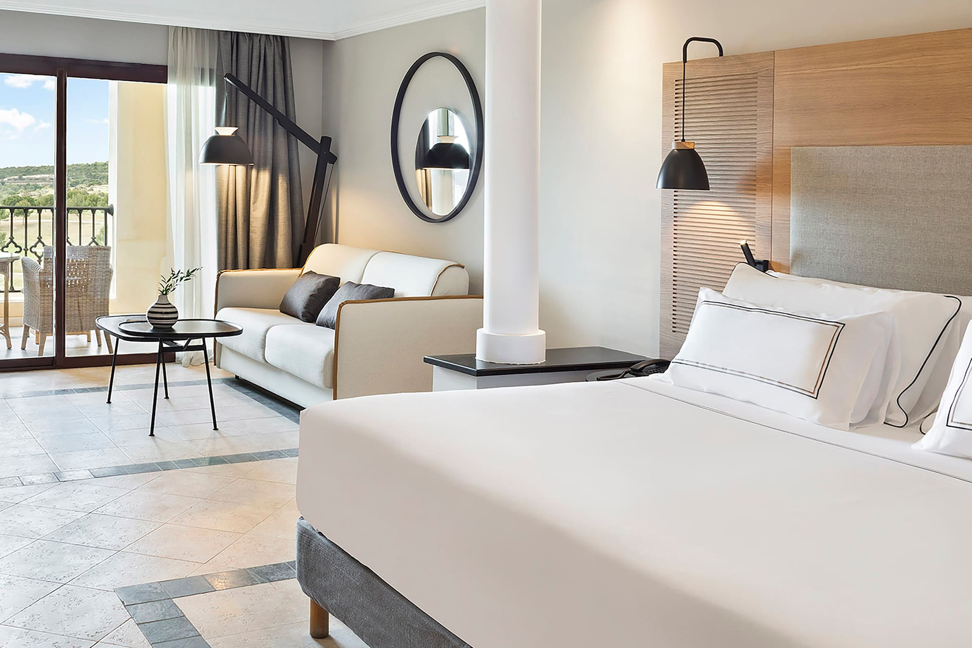 a room with a bed and couches