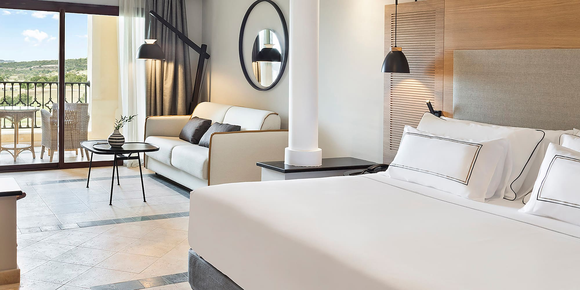 a room with a bed and couches