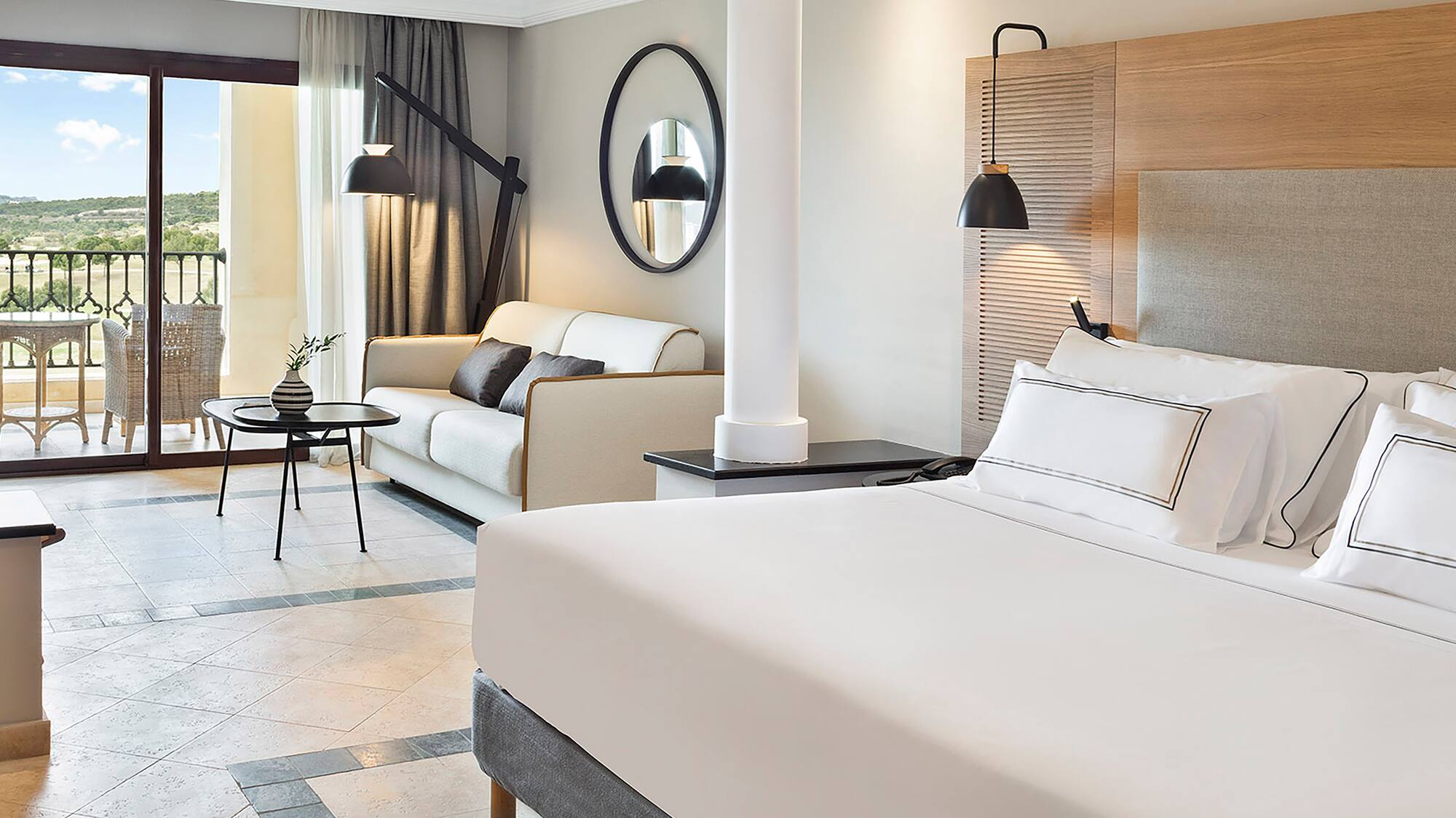 a room with a bed and couches