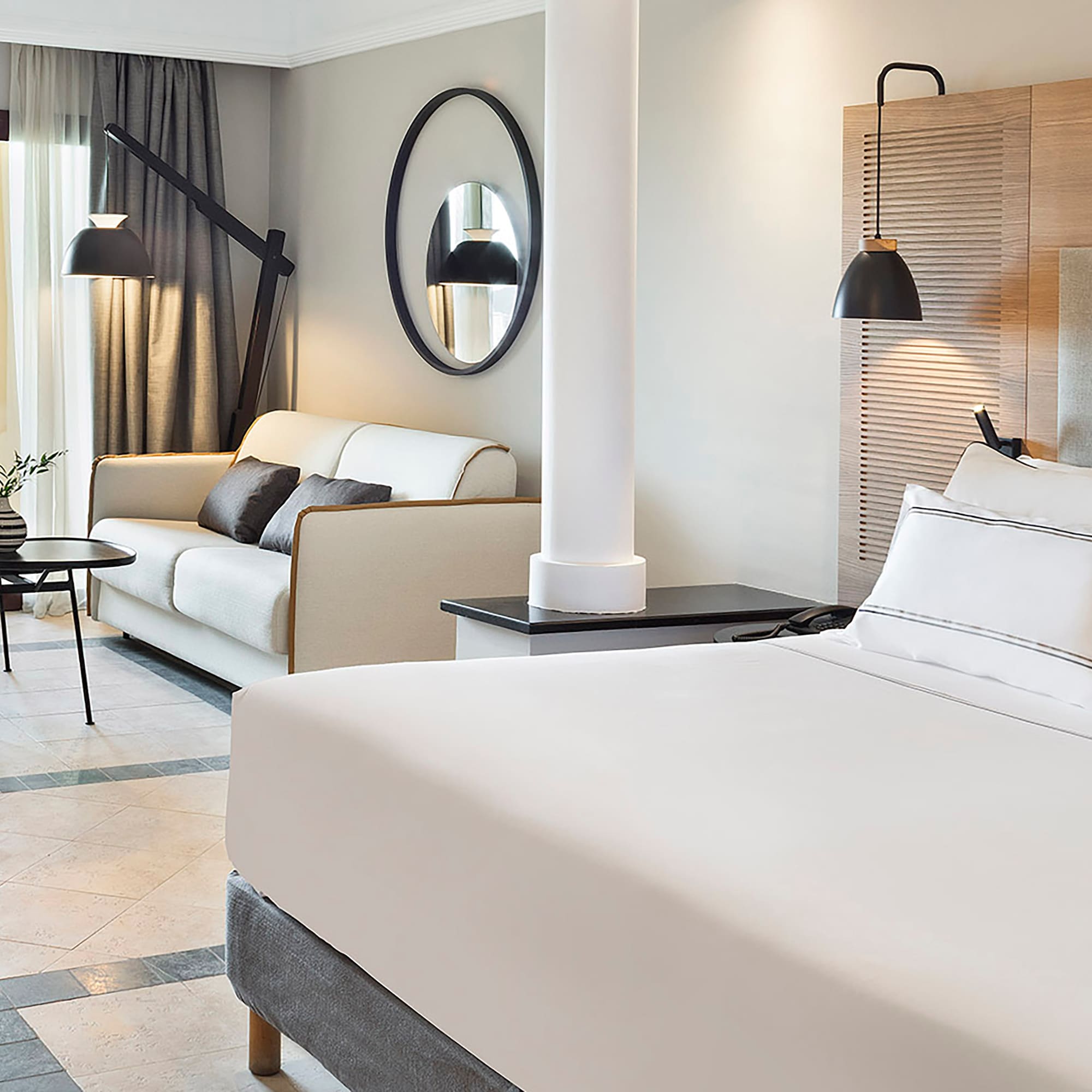 a room with a bed and couches