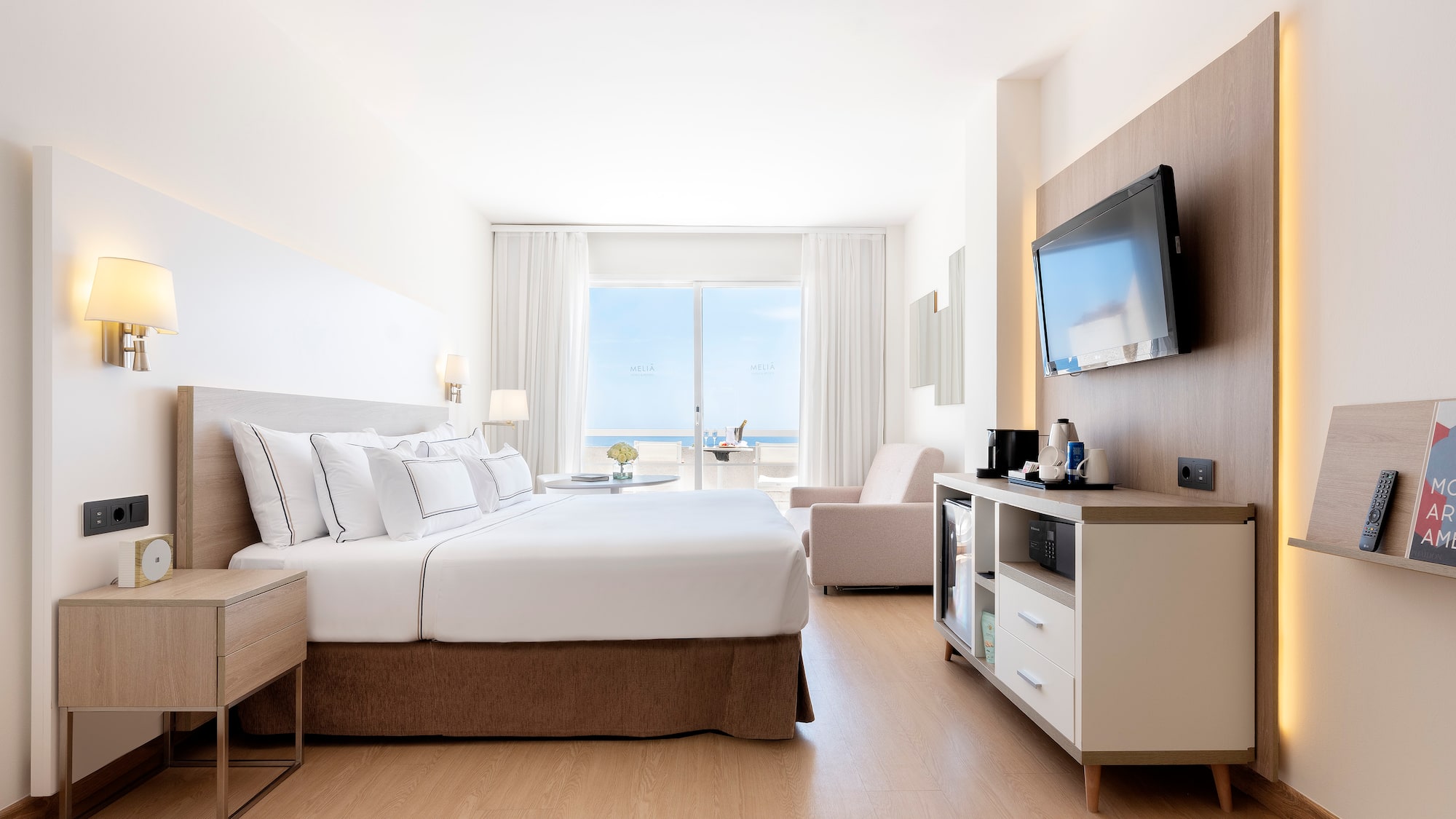 a room with a bed and a television