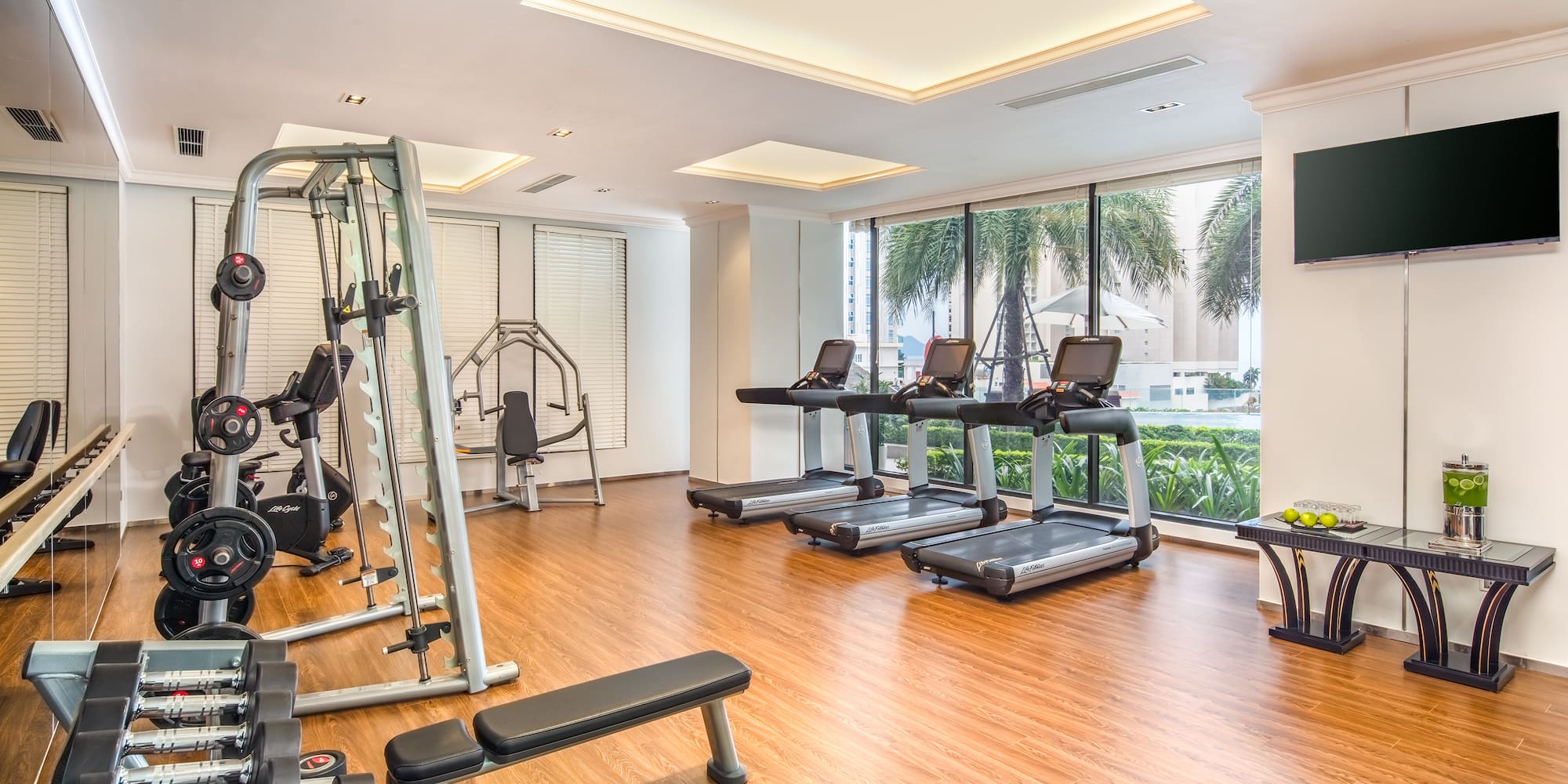 a room with exercise equipment and a wood floor