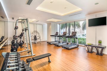 a room with exercise equipment and a wood floor