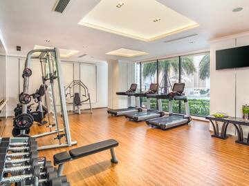 a room with exercise equipment and a wood floor