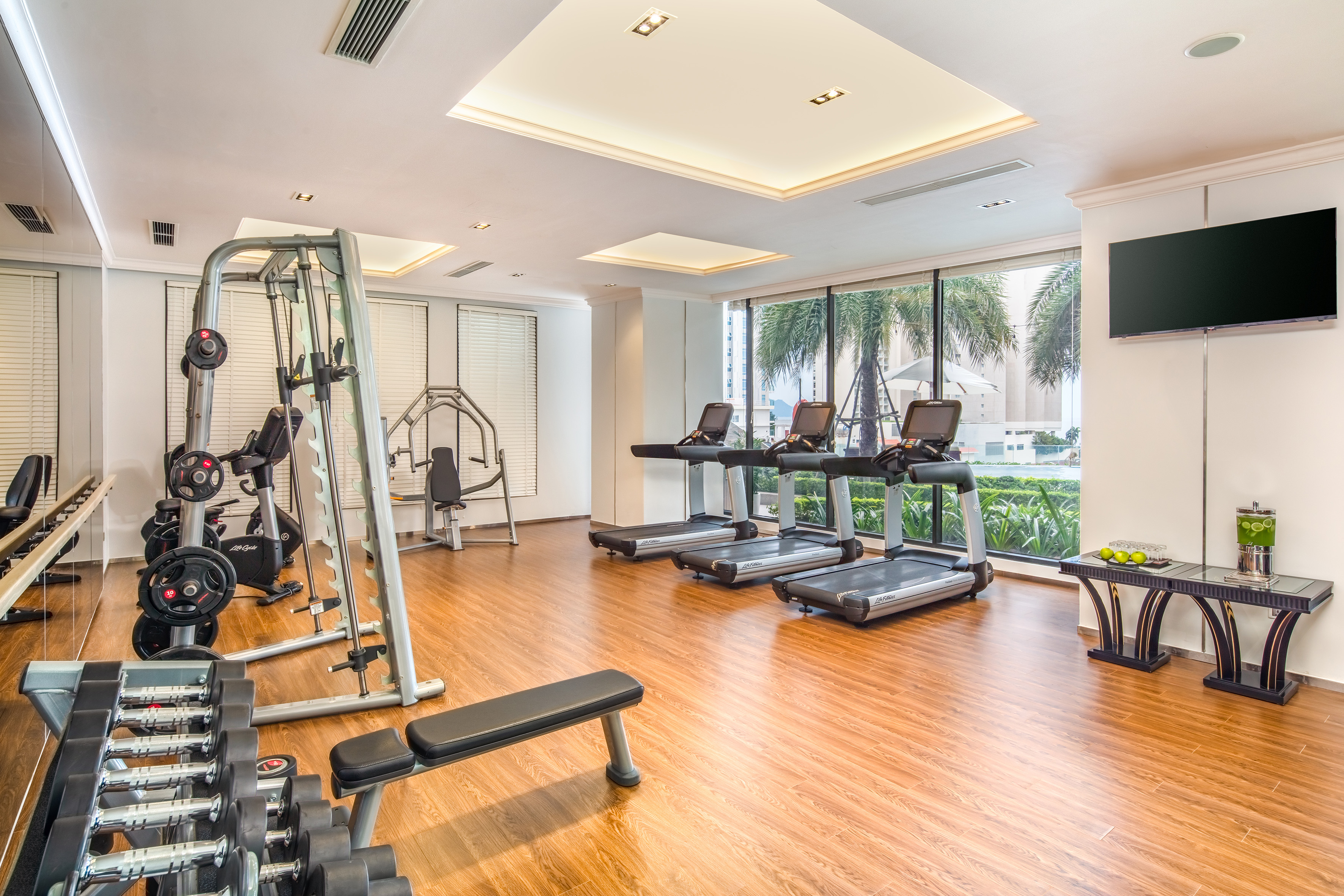 a room with exercise equipment and a wood floor