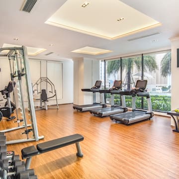 a room with exercise equipment and a wood floor