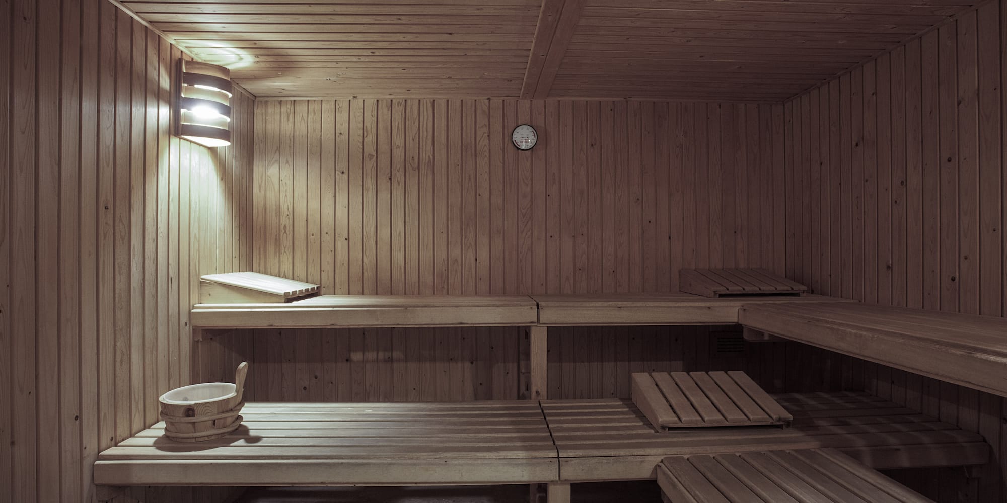 a wooden sauna with a clock