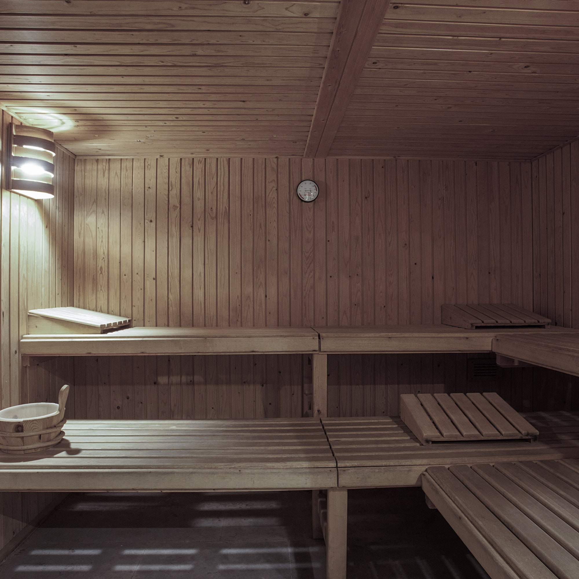 a wooden sauna with a clock
