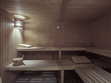 a wooden sauna with a clock