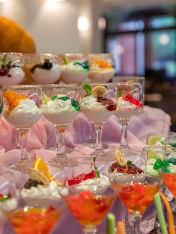 a group of glasses of desserts