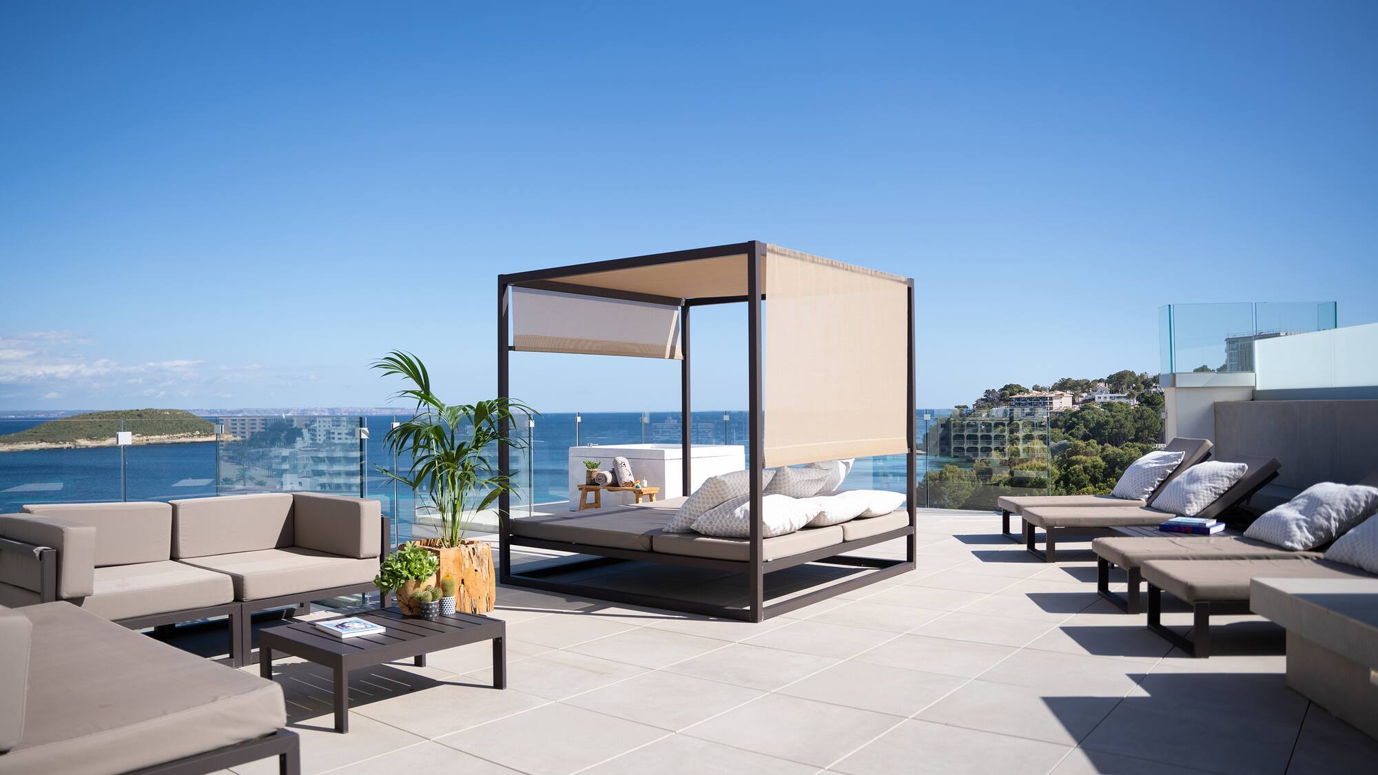 a patio with a canopy and chairs on a sunny day