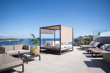 a patio with a canopy and chairs on a sunny day