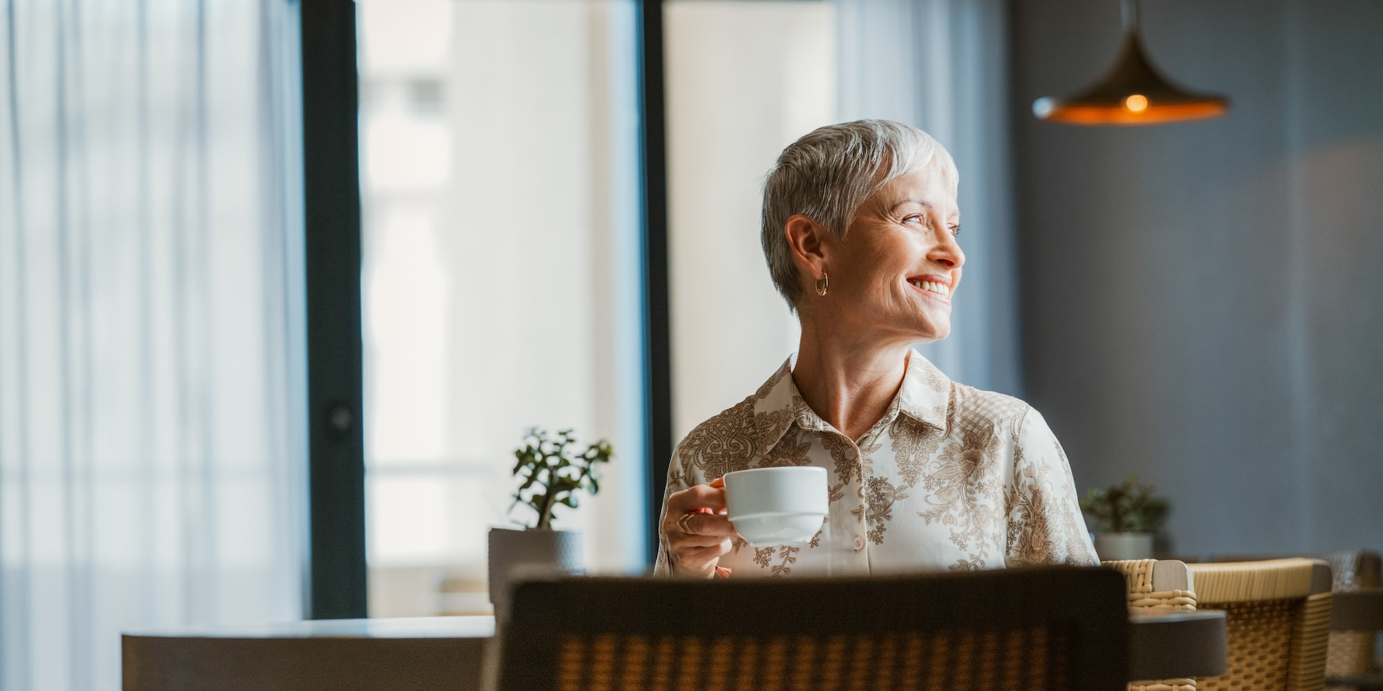 a woman holding a cup of coffee