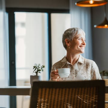 a woman holding a cup of coffee