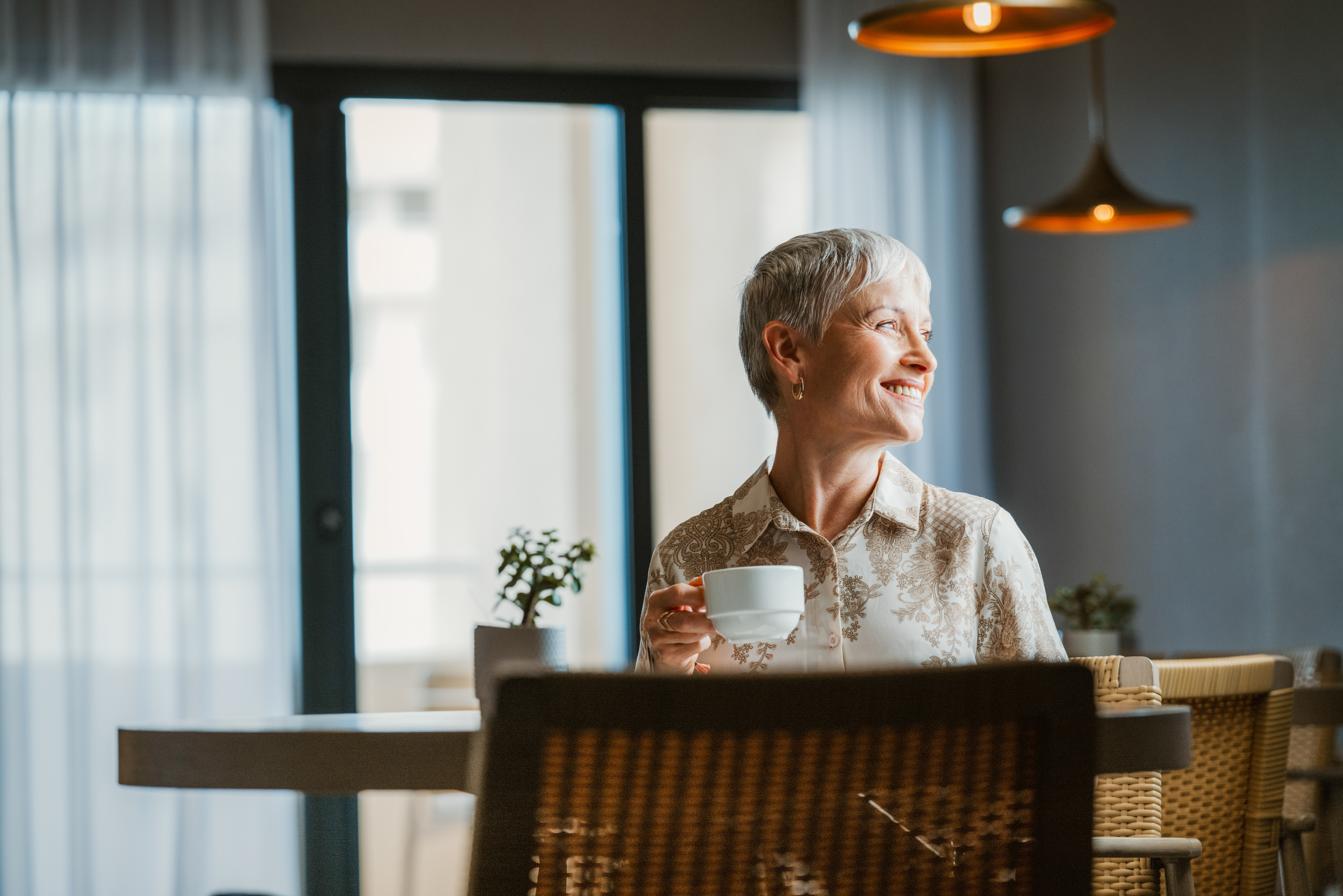 a woman holding a cup of coffee