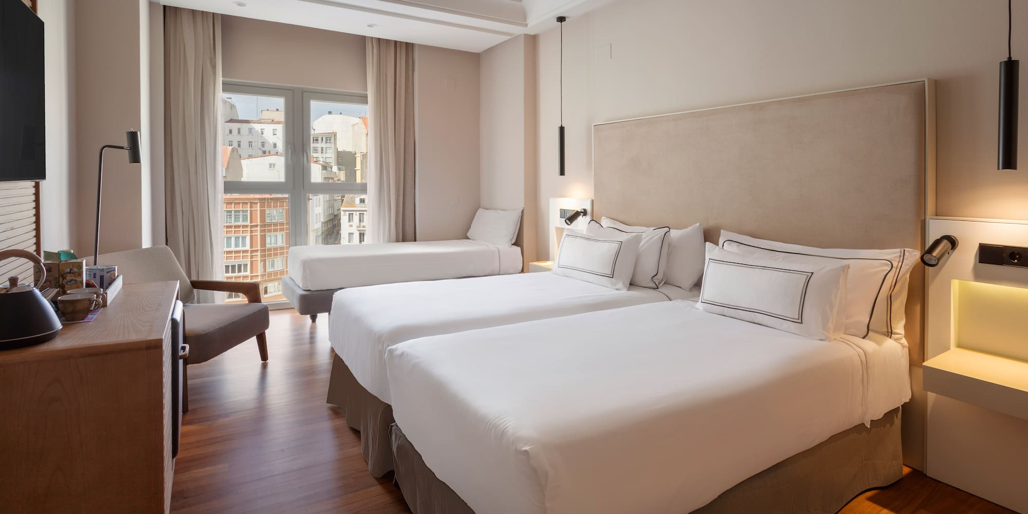 a room with two beds and a chair