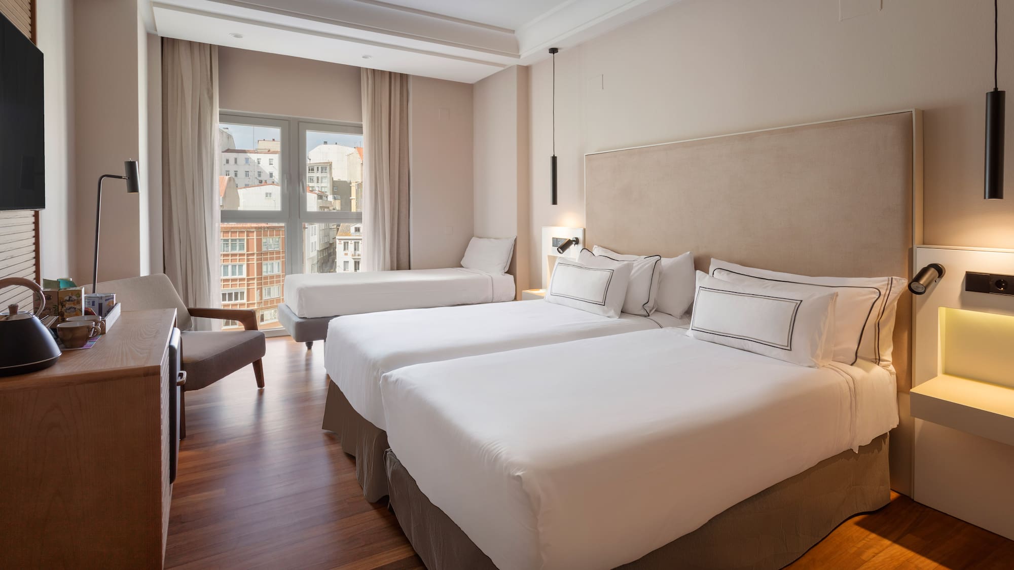 a room with two beds and a chair